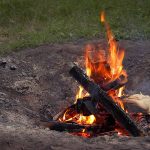 Small fire in backyard fire pit - travel - camping danger