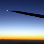 Travel photo - plane wing in the air - moon and mercury during sunset