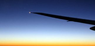 Travel photo - plane wing in the air - moon and mercury during sunset