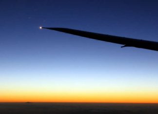 Travel photo - plane wing in the air - moon and mercury during sunset